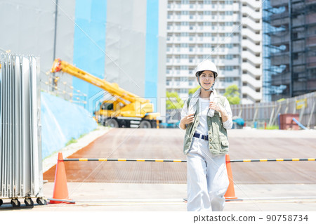 A woman working at a construction site A woman working at a construction site 90758734