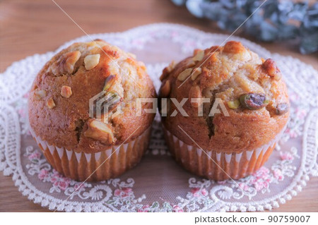 Muffins served on white lace Nut muffins Raisin muffins Freshly baked 90759007