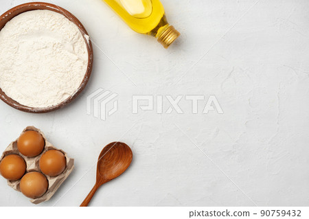 Preparation for baking. Eggs and flour on white background 90759432