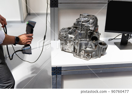 Engineer scans the detail with 3D scanner 90760477
