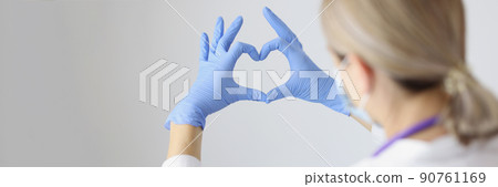 Medical worker form heart with hands wearing protective gloves 90761169