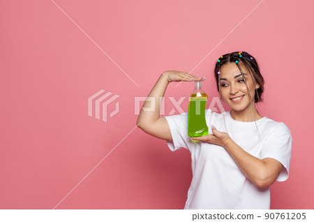 Happy beautiful woman with plastic bottle on pink background Happy beautiful woman with plastic bottle on pink background 90761205
