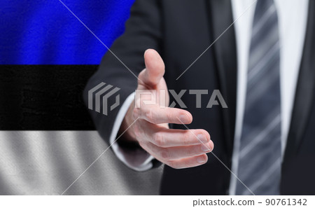 Welcome to the Estonia. Hand on Estonian flag background. Welcome to the Estonia. Hand on Estonian flag background. 90761342