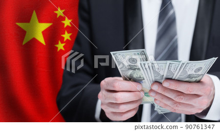 Hands holding dollar money on flag of China Hands holding dollar money on flag of China 90761347