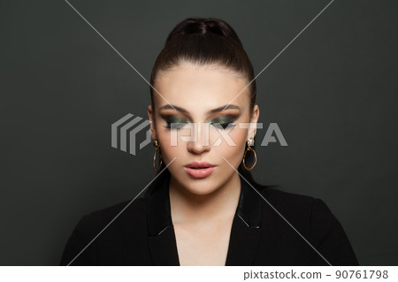Beautiful fashion model woman face with dark green smokey eyes makeup closeup portrait 90761798