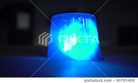 Blue flashing warning light in the dark close up. 90765408