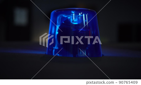 Blue flashing warning light in the dark close up. Blue flashing warning light in the dark close up. 90765409