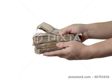 A picture of a hand holding a large amount of money in front of her ,with Clipping Path. 90765656