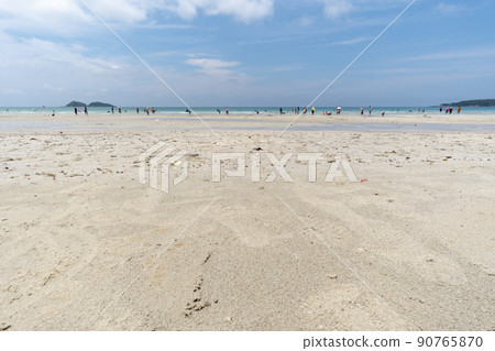 People take a dip in the sea and stroll on the white sand. People take a dip in the sea and stroll on the white sand. 90765870