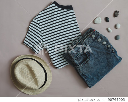 Summer fashion, vacation on sea. flat lay with t-shirt, denim shorts, straw hat top view Summer fashion, vacation on sea. flat lay with t-shirt, denim shorts, straw hat top view 90765903