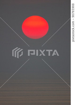 The sun is falling into the sea. It is colour orang The sky and the sea is dark The sun is falling into the sea. It is colour orang The sky and the sea is dark 90765908