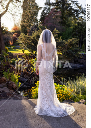 White Caucasian Adult Woman in a Wedding Dress standing outside in nature 90766357