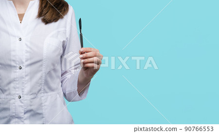 female surgeon holding surgical instrument 90766553