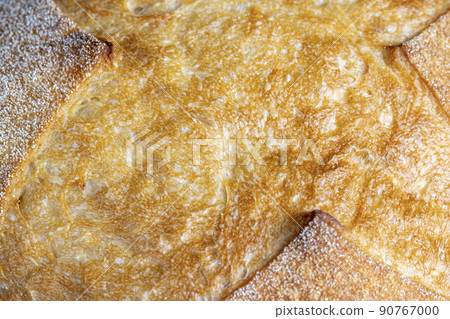 a whole loaf of bread on a cutting wooden board 90767000