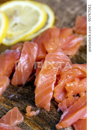cutting fish fillets during the preparation of a dish of red salmon fish cutting fish fillets during the preparation of a dish of red salmon fish 90767061