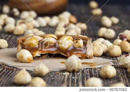 delicious tartlet cake with soft caramel and roasted hazelnut delicious tartlet cake with soft caramel and roasted hazelnut 90767062