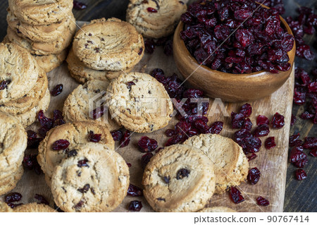 delicious dried cookies made of high-quality flour with dried red cranberries on the table 90767414