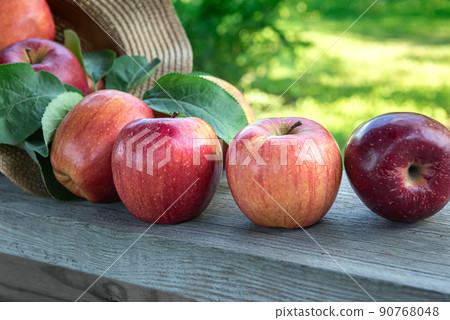 Close-up of red apples on old wooden plank 90768048