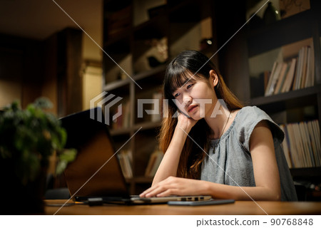Happy Beautiful Asian Student woman working on laptop in modern library room Happy Beautiful Asian Student woman working on laptop in modern library room 90768848