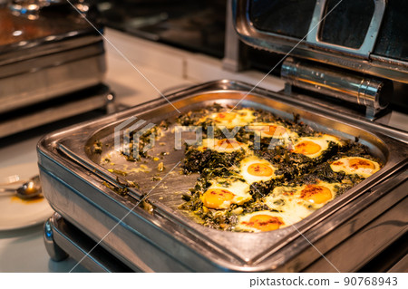 Breakfast buffet food in heating trays in hotel restaurant with eggs with spinach 90768943