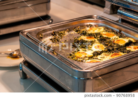 All-inclusive buffet food in heating trays in hotel restaurant with eggs with spinach for breakfast All-inclusive buffet food in heating trays in hotel restaurant with eggs with spinach for breakfast 90768958