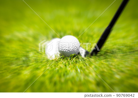 Closeup of hitting golf ball with golf iron club golf course wih motion blur effect 90769042