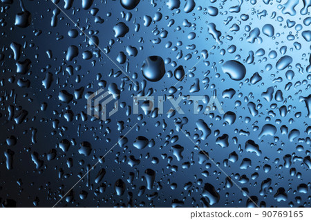 Water drops close-up on a blue glass background. Water drops close-up on a blue glass background. 90769165