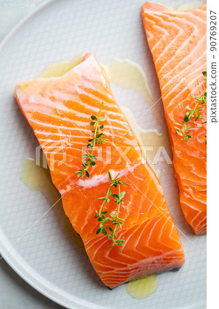 Fresh salmon fillet with herbs on a plate for delicious salmon steak. 90769207
