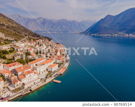 Scenic panorama view of the historic town of Perast at famous Bay of Kotor with blooming flowers on a beautiful sunny day with blue sky and clouds in summer, Montenegro, southern Europe 90769514