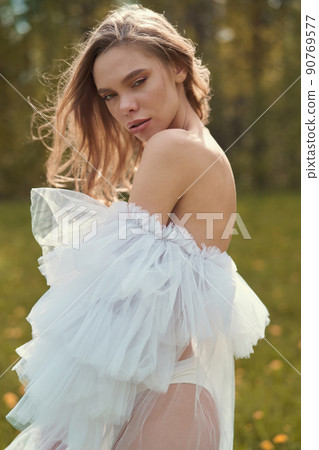 Sexy blonde in dress posing in nature. Art portrait of nude woma 90769577