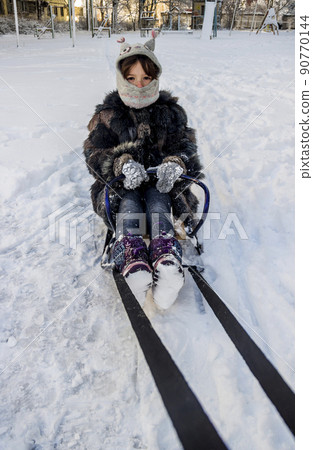 little girl on sledge 90770144