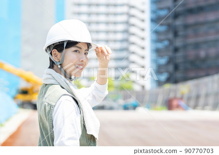 Female worker working at a construction site 90770703