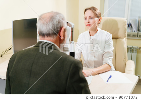 ophthalmologist examination of elderly man on corneo topographer.modern clinic 90771072