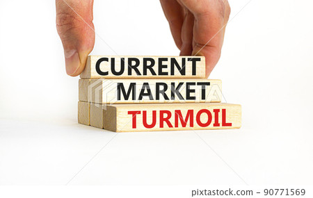 Current market turmoil symbol. Concept words Current market turmoil on wooden blocks on a beautiful white table white background. Businessman hand. Business, finacial current market turmoil concept. Current market turmoil symbol. Concept words Current market turmoil on wooden blocks on a beautiful white table white background. Businessman hand. Business, finacial current market turmoil concept. 90771569