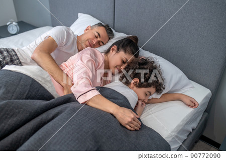 Cute family sleeping together in one bed Cute family sleeping together in one bed 90772090