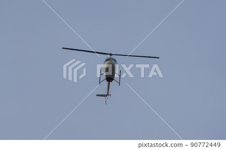 helicopter in flight against the background of blue sky during sunset helicopter in flight against the background of blue sky during sunset 90772449