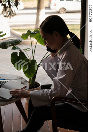 Asian female freelancer working in a cafe 90772895