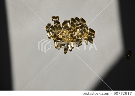 Omega 3. Transparent fish oil capsules on a gray background Omega 3. Transparent fish oil capsules on a gray background 90772917