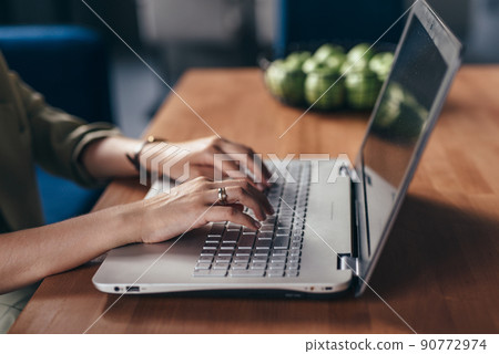 Woman sitting at desk with laptop Woman sitting at desk with laptop 90772974