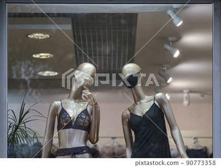 Two female mannequins wear in mask looking on you, underwear dressed. Two female mannequins wear in mask looking on you, underwear dressed. 90773358