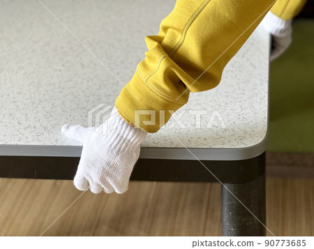 Hands with gloves carrying kotatsu 90773685