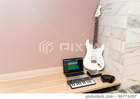 Laptop and white electric guitar 90774287