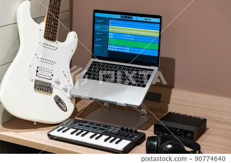 Laptop and white electric guitar Laptop and white electric guitar 90774640