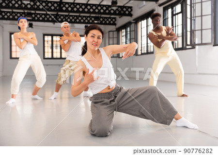 Team of dancers performing hip-hop dance Team of dancers performing hip-hop dance 90776282