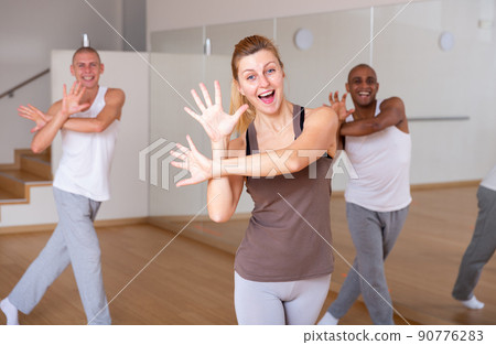 Woman dancing at group lesson in studio Woman dancing at group lesson in studio 90776283