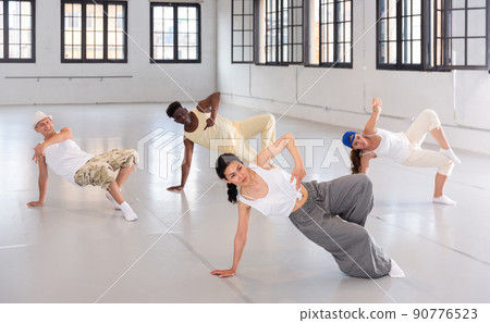Group of young people learning modern dance movements Group of young people learning modern dance movements 90776523