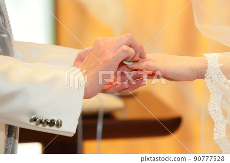 Happy bride and groom ring exchange scene Happy bride and groom ring exchange scene 90777528