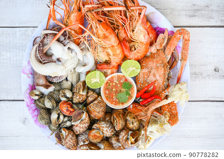seafood plate with shrimp shellfish crab squid cockle spotted babylon with seafood sauce chili lemon lime serve on dining table, shrimps prawns seafood buffet menu cooked food seafood plate with shrimp shellfish crab squid cockle spotted babylon with seafood sauce chili lemon lime serve on dining table, shrimps prawns seafood buffet menu cooked food 90778282