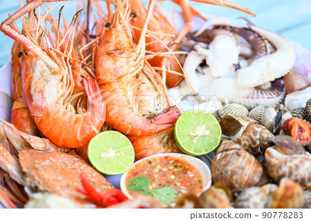 seafood plate with shrimp shellfish crab squid cockle spotted babylon with seafood sauce chili lemon lime serve on dining table, shrimps prawns seafood buffet menu cooked food seafood plate with shrimp shellfish crab squid cockle spotted babylon with seafood sauce chili lemon lime serve on dining table, shrimps prawns seafood buffet menu cooked food 90778283