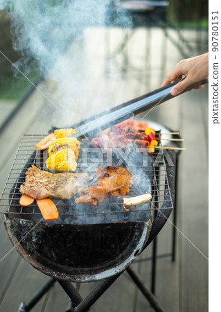 delicious grilled meat with smoke, BBQ with vegetables in outdoor. Barbecue, Party, lifestyle and picnic concept delicious grilled meat with smoke, BBQ with vegetables in outdoor. Barbecue, Party, lifestyle and picnic concept 90780151